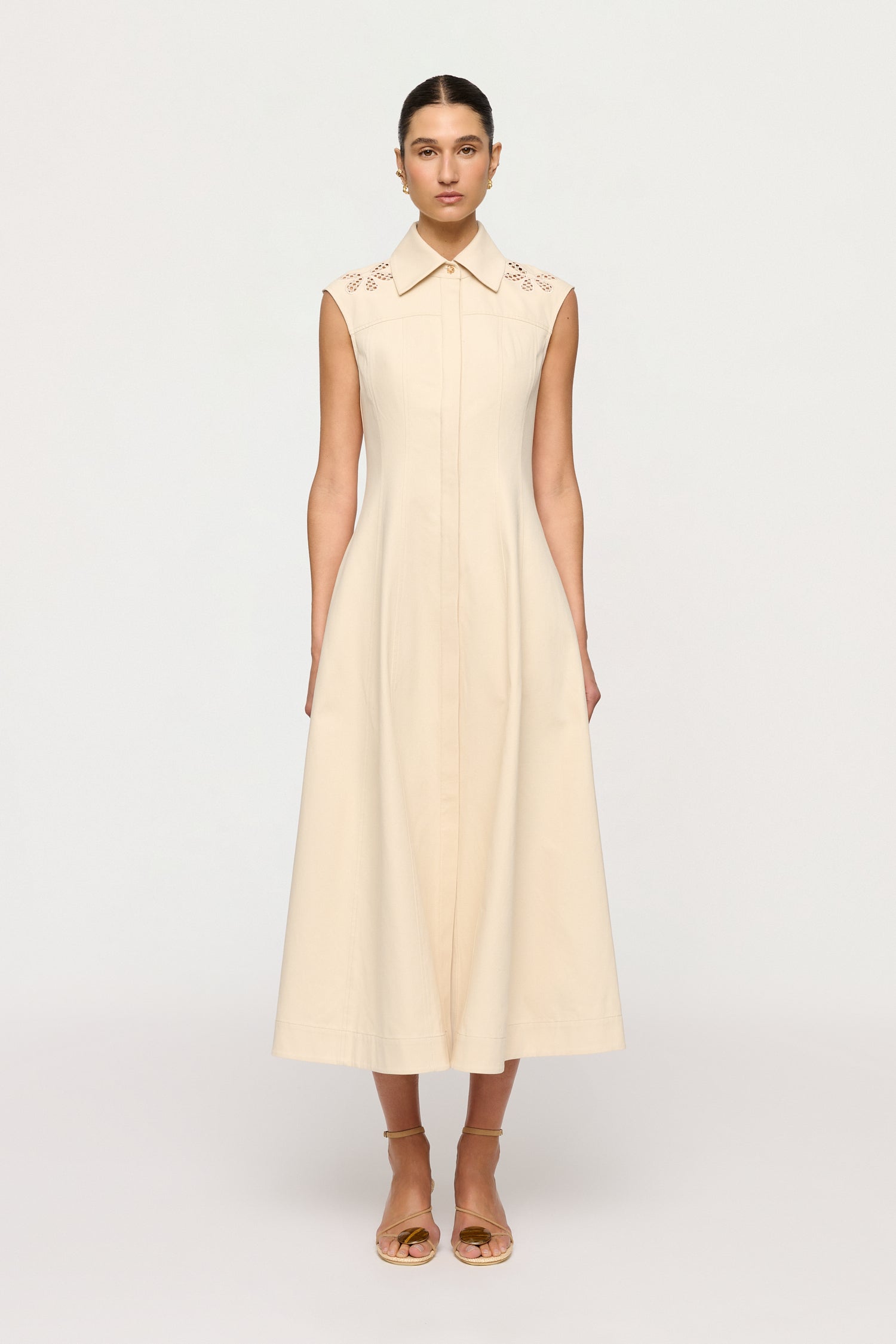 Woman wearing a beige dress on a white background