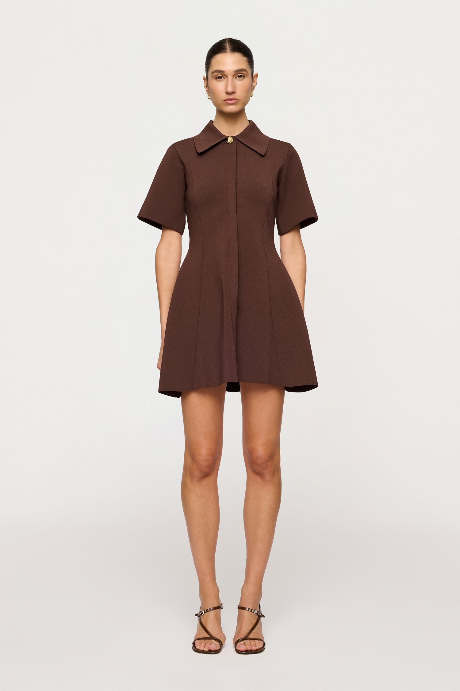 Woman wearing a brown dress on a white background