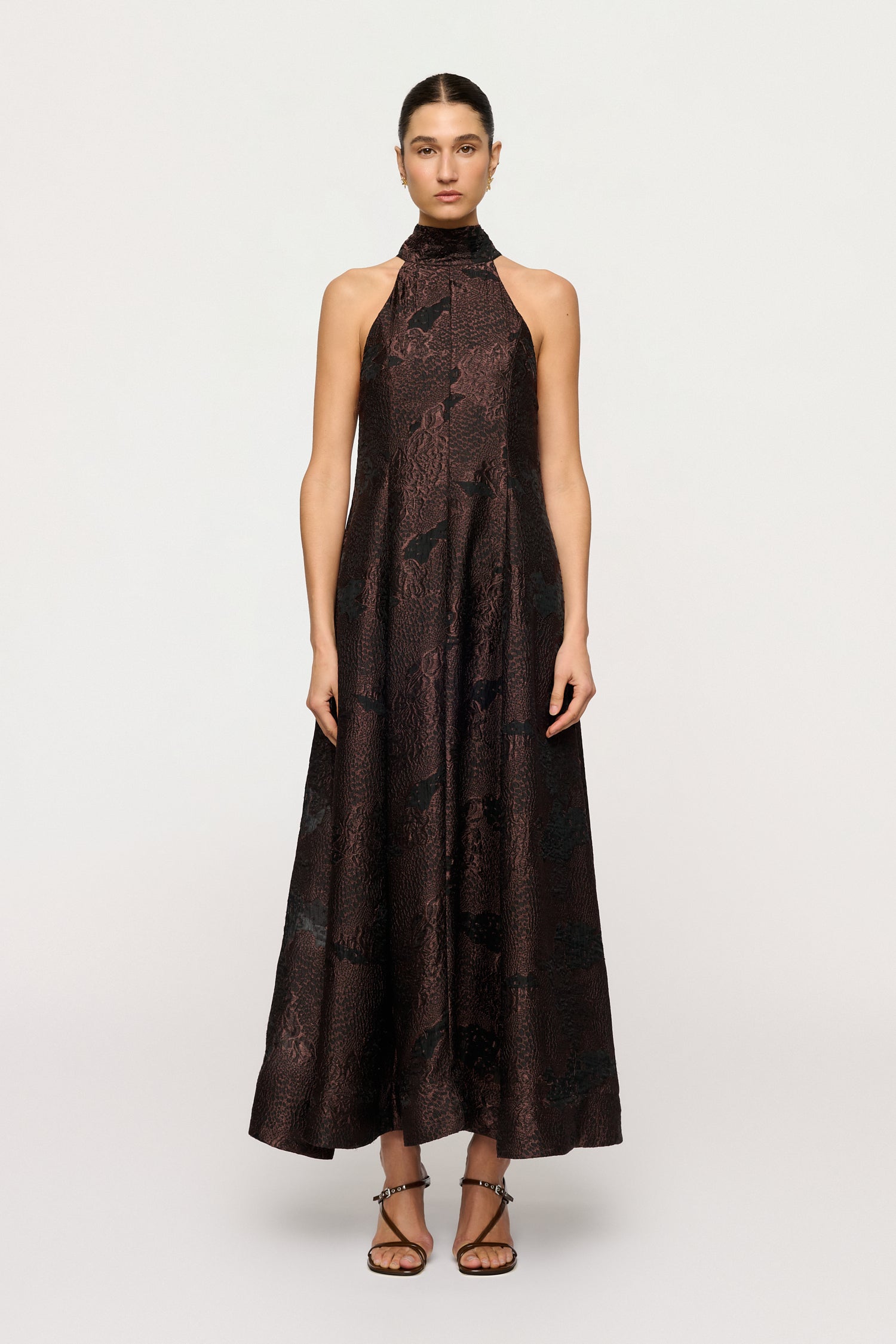 Woman wearing a black patterned dress on a white background