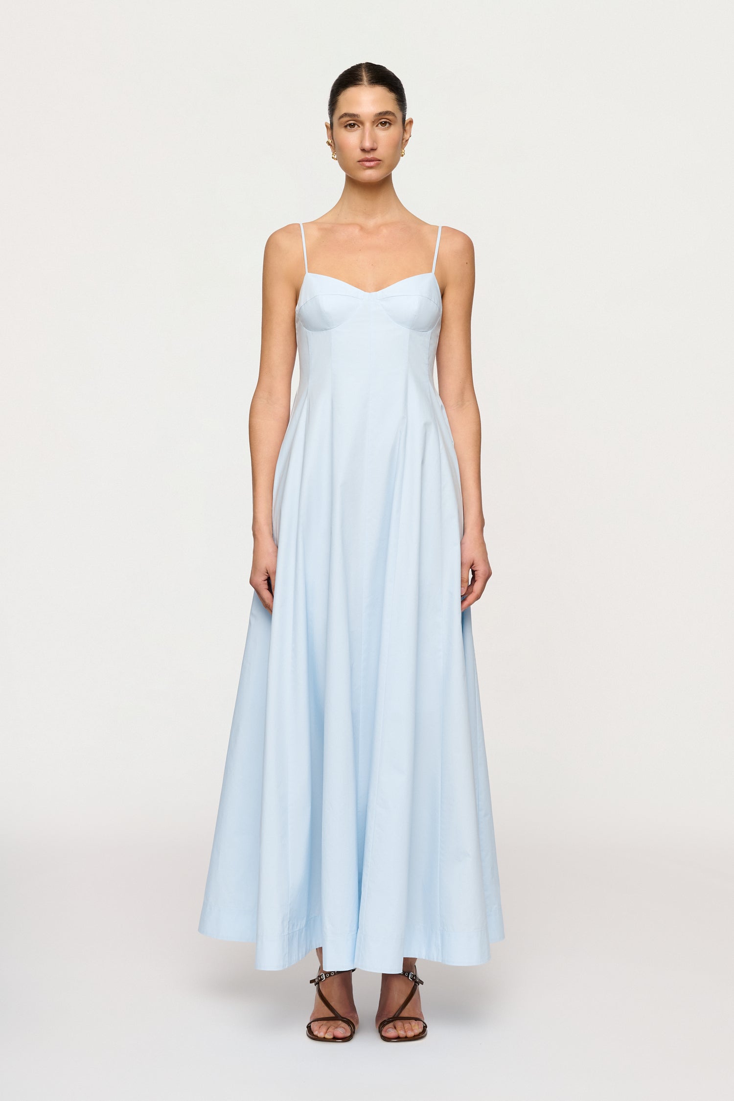 Woman wearing a light blue dress on a white background