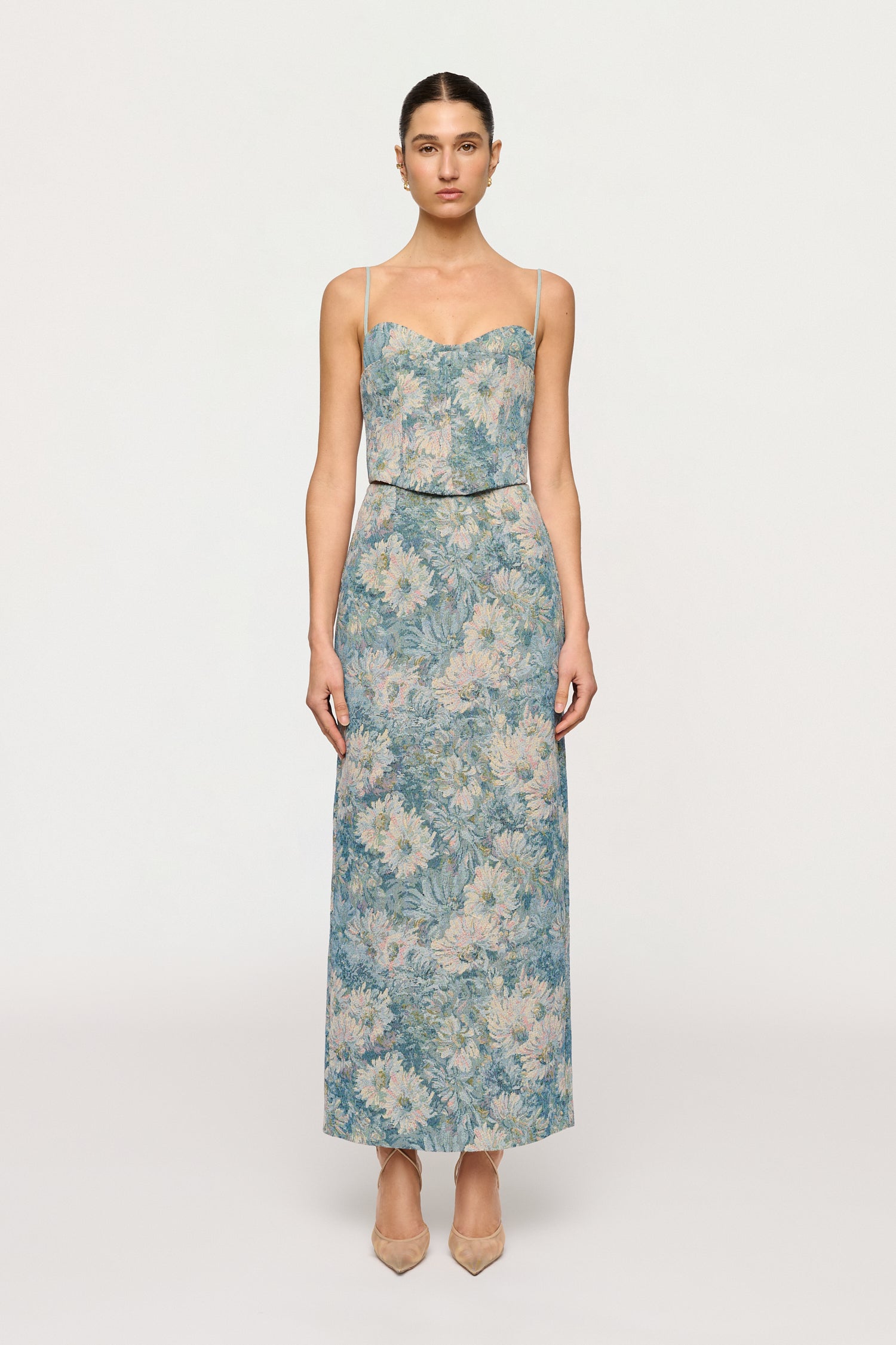 Woman wearing a floral strapless dress on a white background