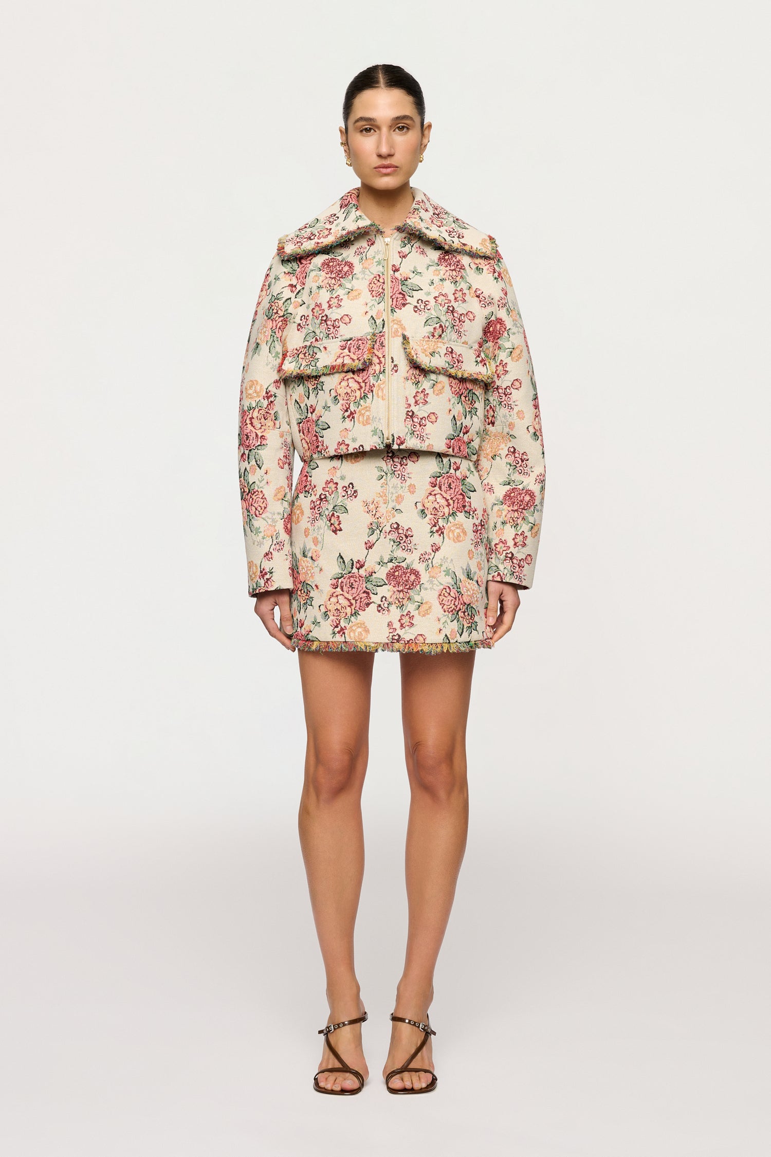 Woman wearing a floral two-piece outfit on a white background