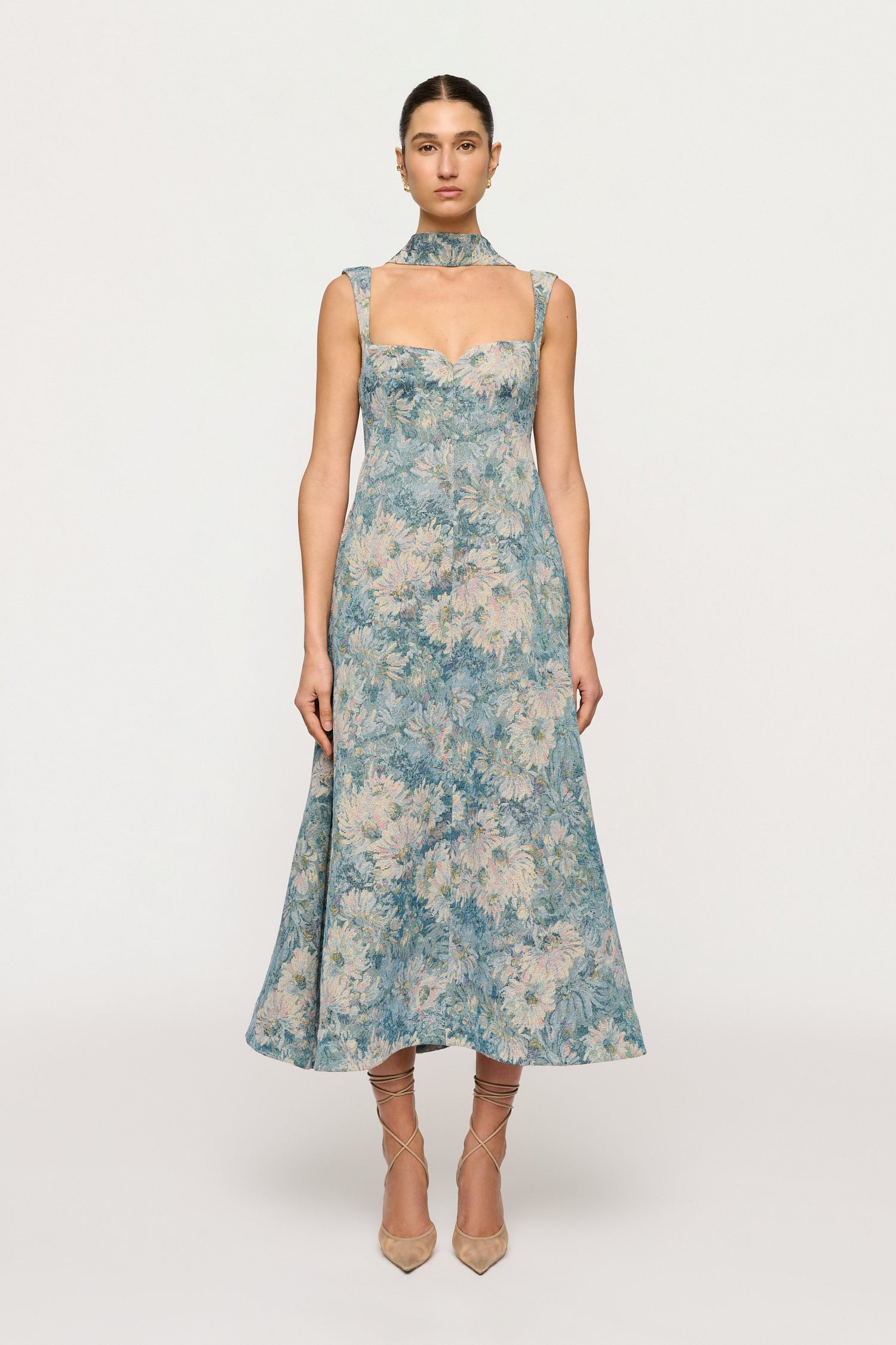 Woman wearing a Clea floral dress on a white background