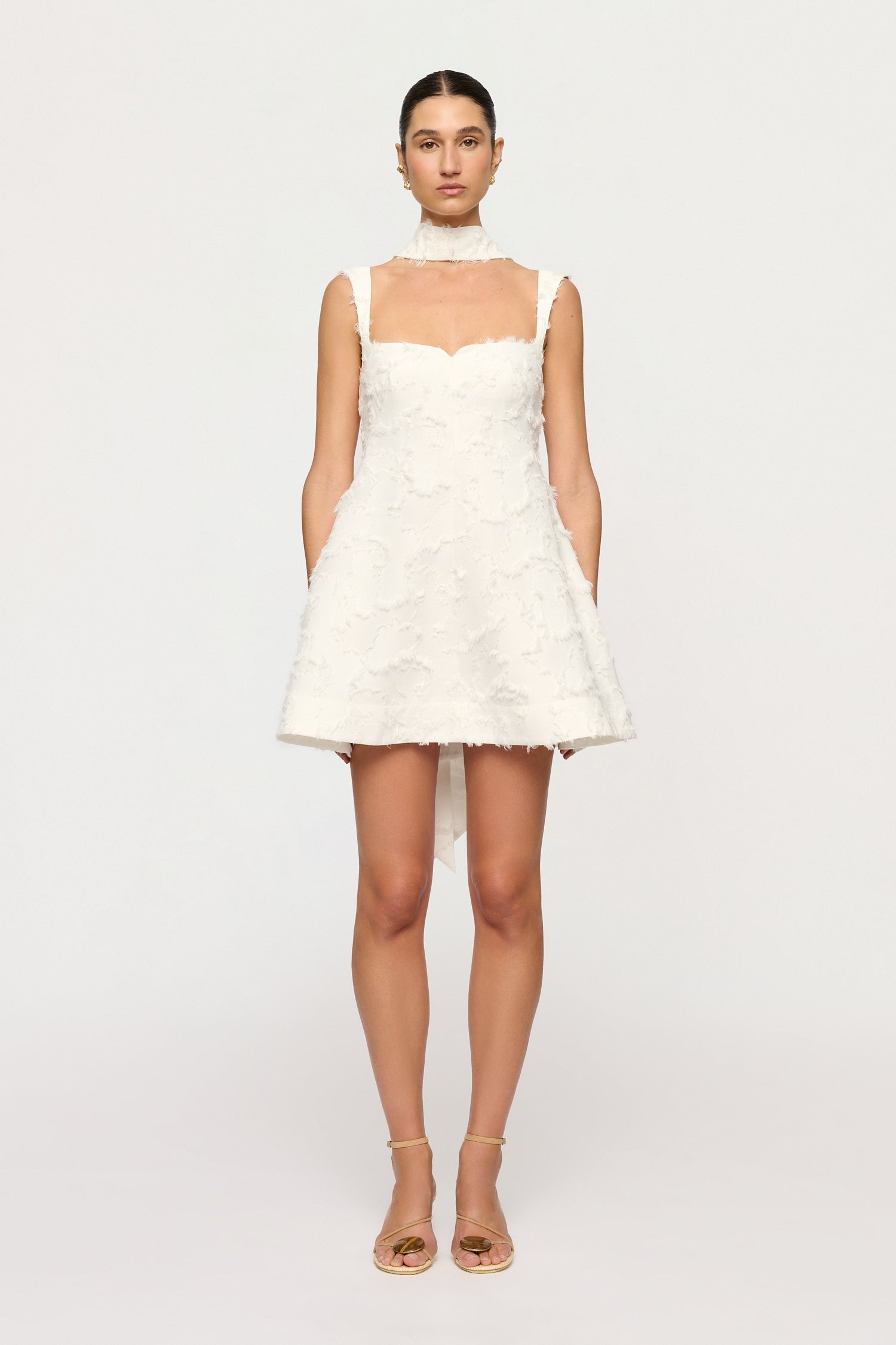 White lace dress worn by a model on a white background