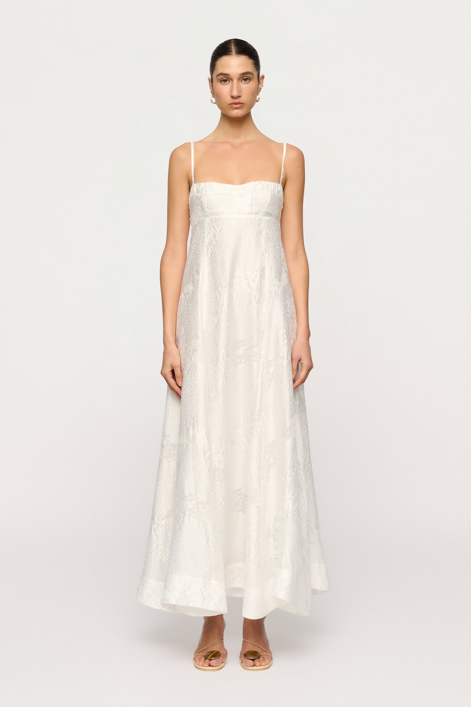 Woman wearing a white dress on a white background