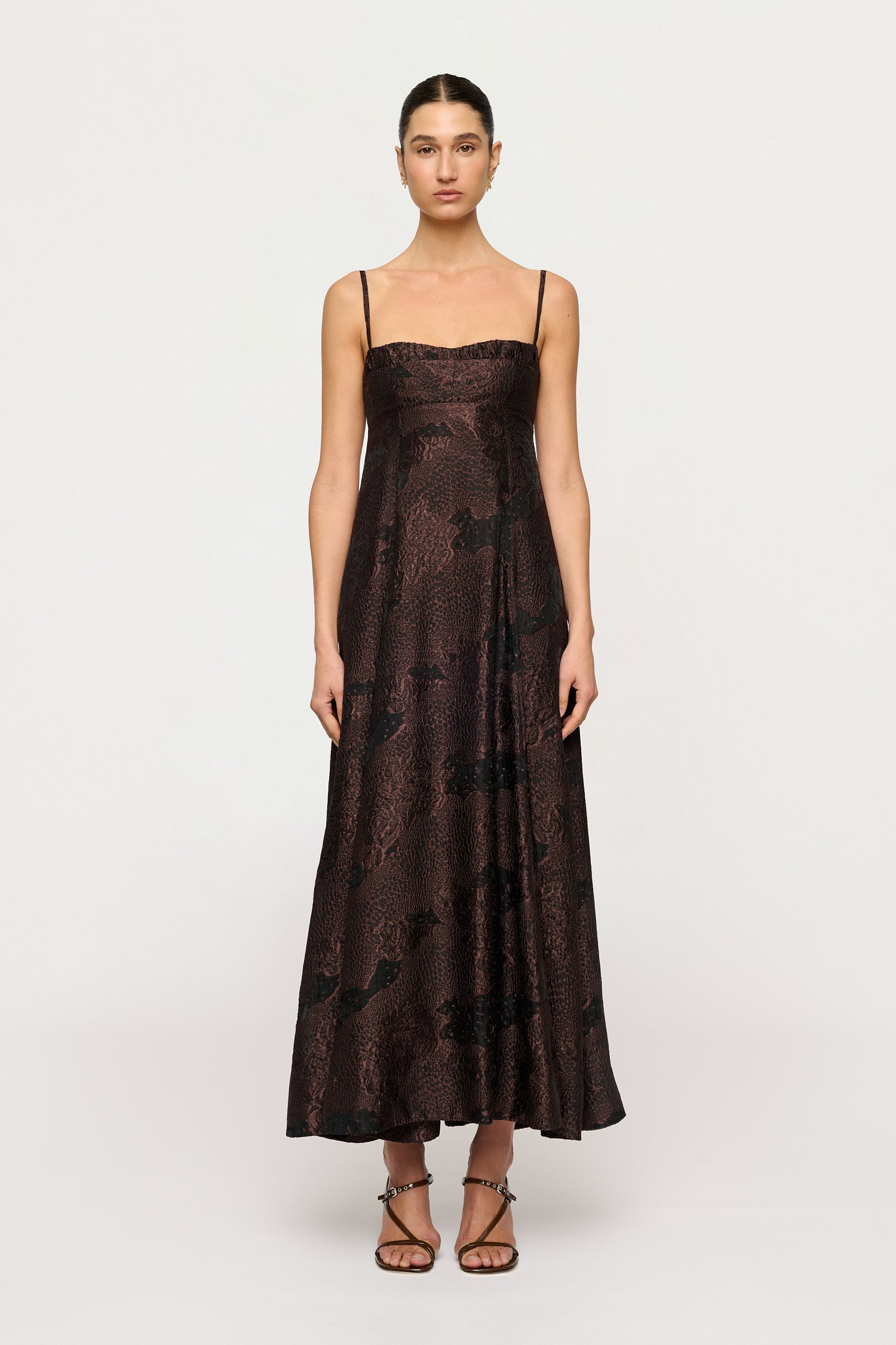 Woman wearing a dark floral dress on a white background