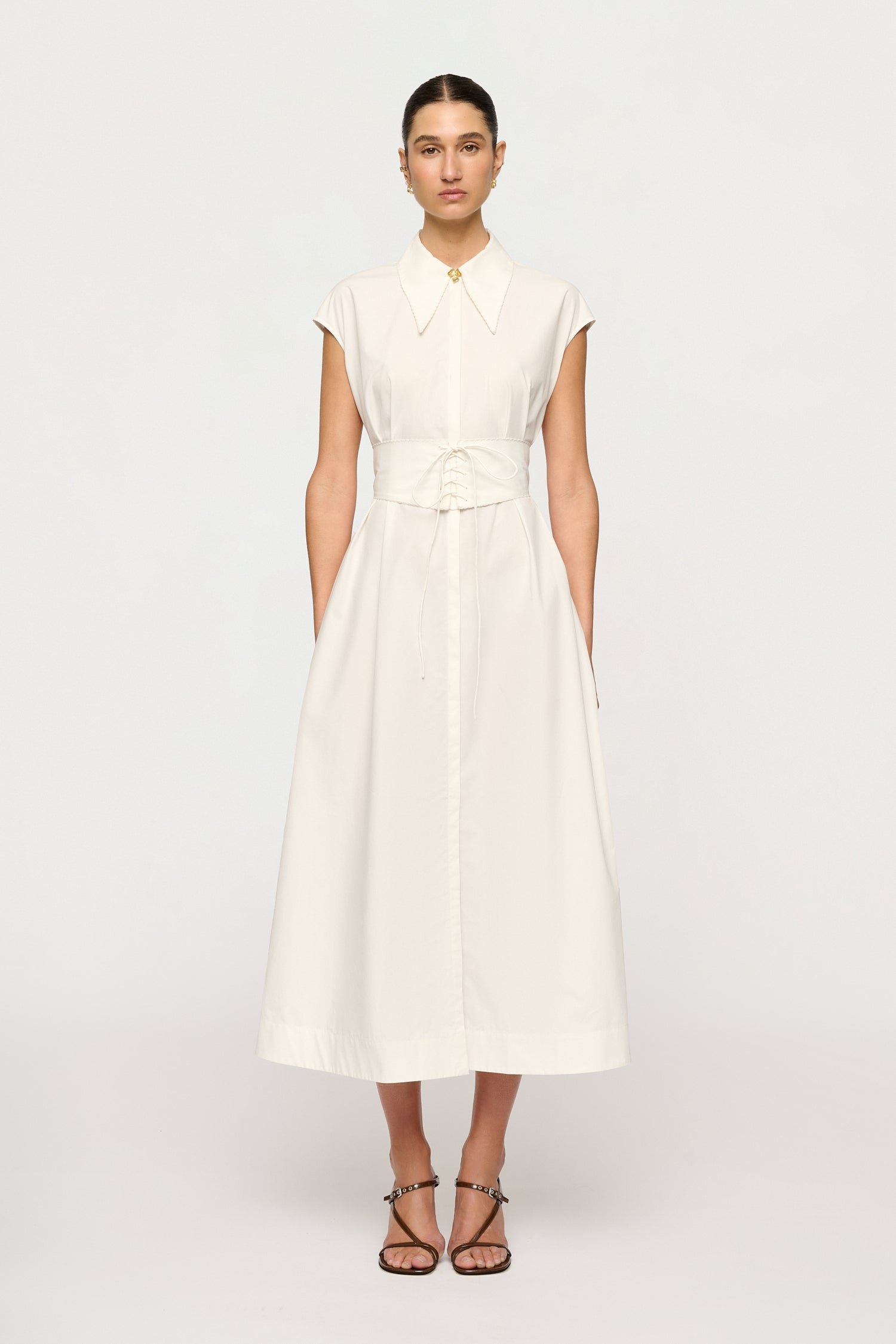 Woman wearing a white dress on a white background